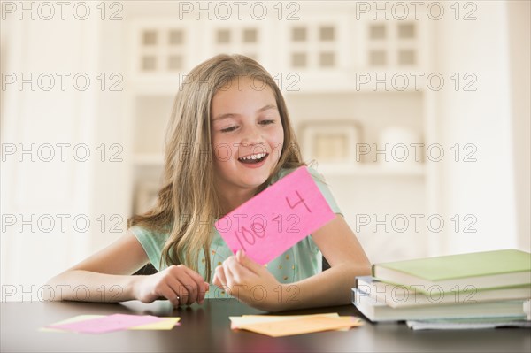 Caucasian girl studying with flash cards