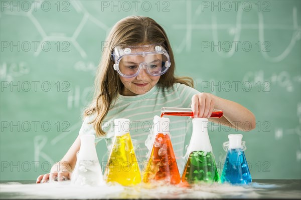 Caucasian girl doing science experiment in classroom