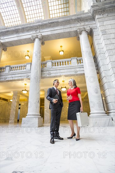 Business people talking in courthouse