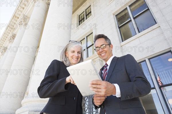 Business people talking outside courthouse