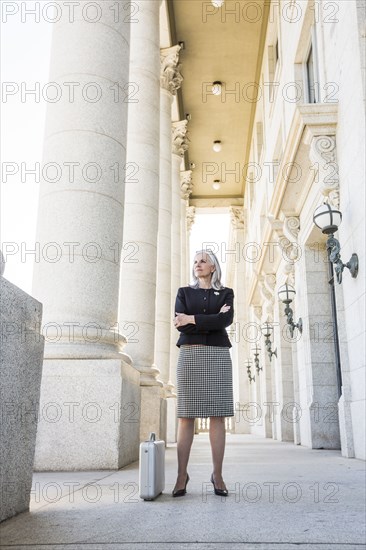 Caucasian businesswoman standing outside courthouse