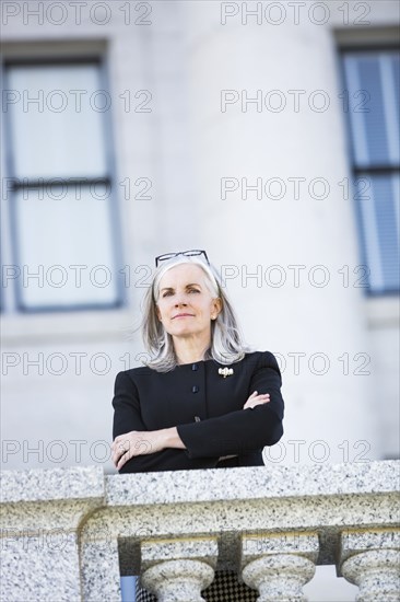 Caucasian businesswoman standing outside courthouse