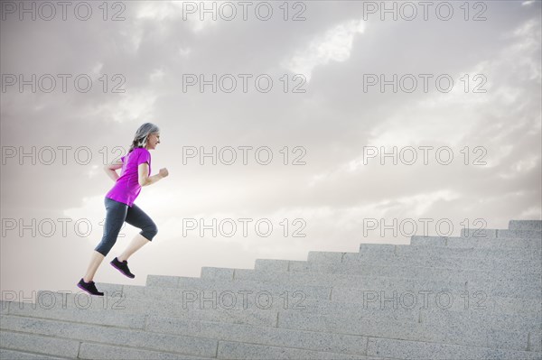 Caucasian woman jogging on steps