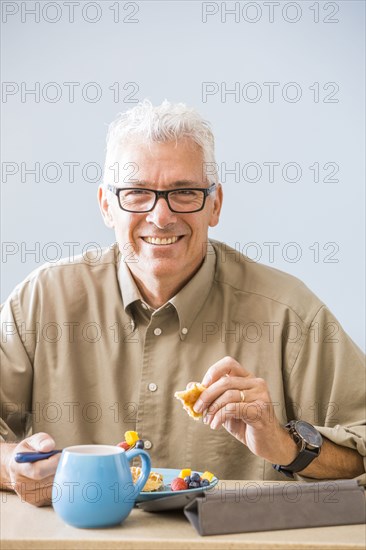 Caucasian man eating at table