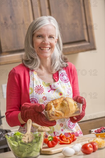 Caucasian woman cooking in kitchen