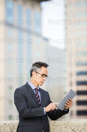 Mixed race businessman using digital tablet