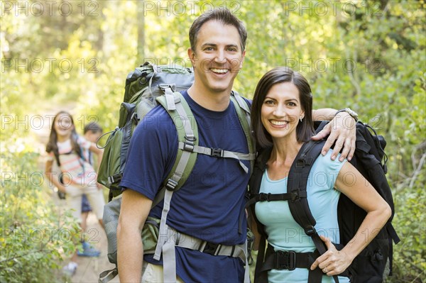 Caucasian family hiking on path