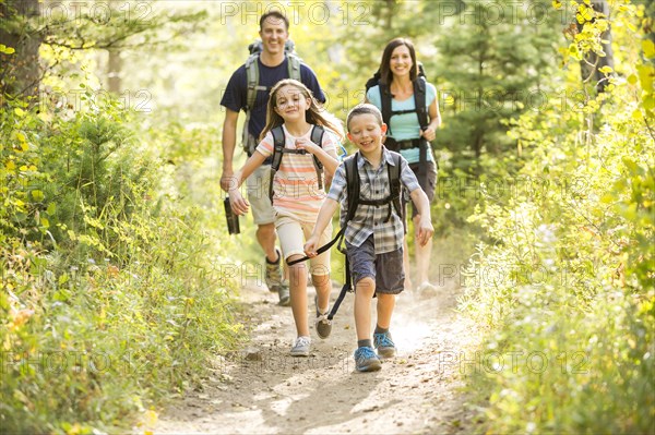 Caucasian family hiking on path