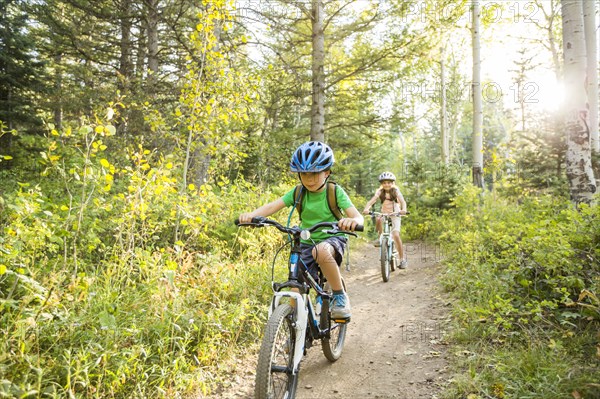 Caucasian children riding mountain bikes