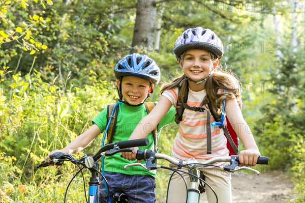 Caucasian children riding mountain bikes