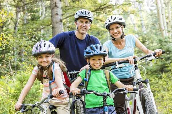 Caucasian family riding mountain bikes