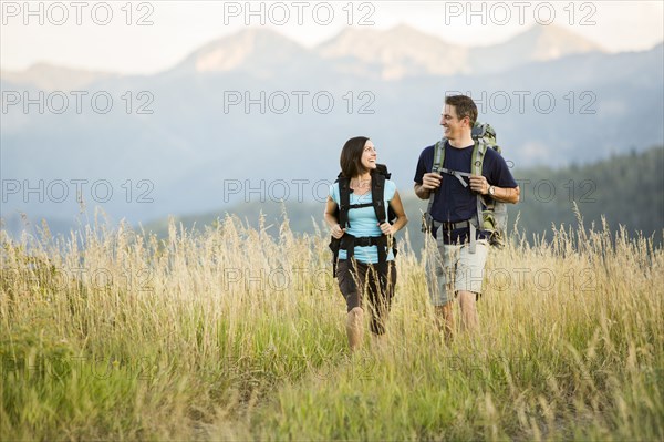 Caucasian couple hiking in remote landscape