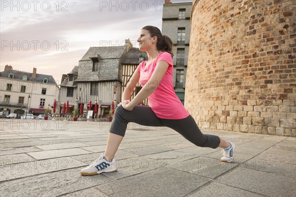 Caucasian woman stretching outdoors