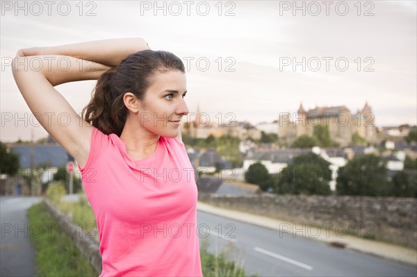 Caucasian woman stretching outdoors