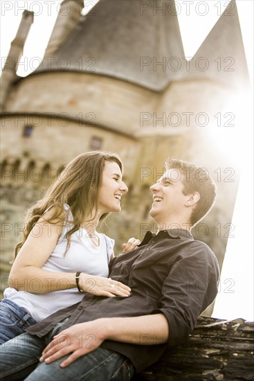 Caucasian couple smiling at castle