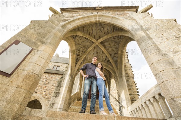 Caucasian couple standing on castle steps