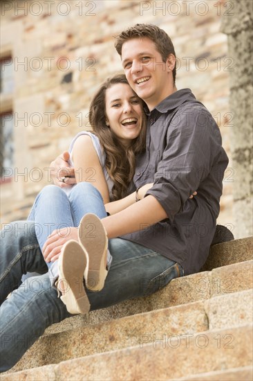 Caucasian couple sitting on castle steps