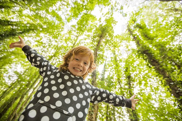 Caucasian girl standing in forest