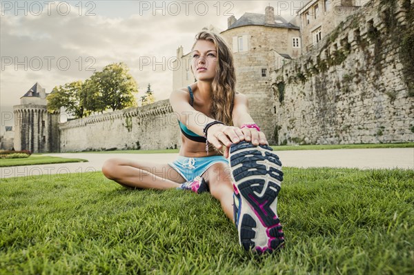 Caucasian woman stretching outdoors