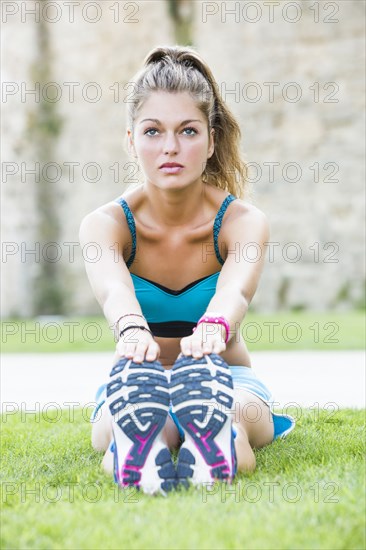 Caucasian woman stretching outdoors