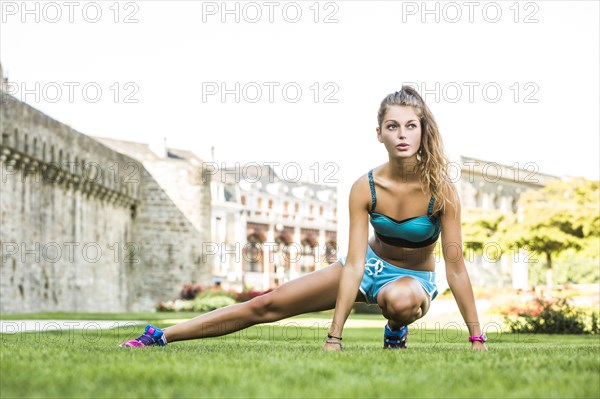 Caucasian woman stretching outdoors