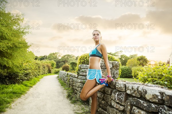 Caucasian woman stretching outdoors