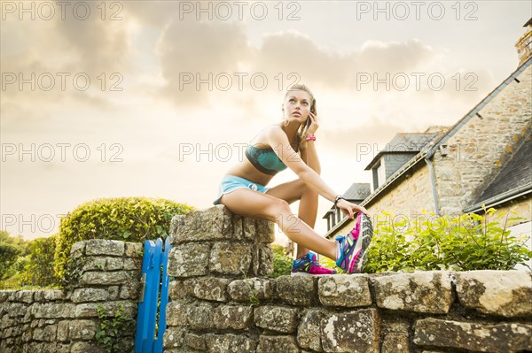 Caucasian woman stretching outdoors