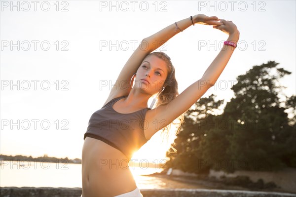 Caucasian woman stretching outdoors