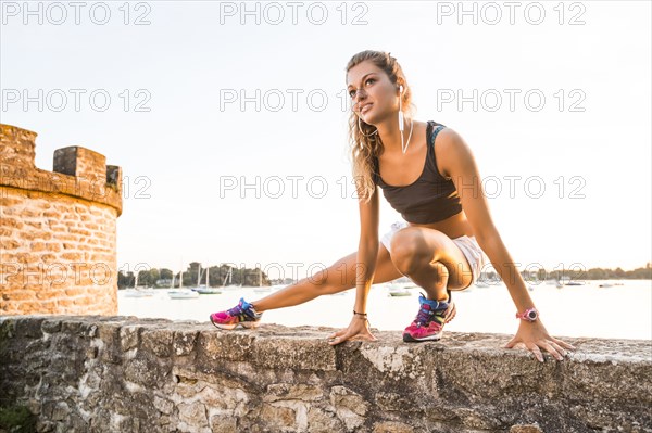Caucasian woman stretching outdoors
