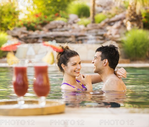 Couple hugging in swimming pool