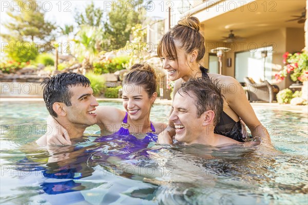 Couples talking in swimming pool