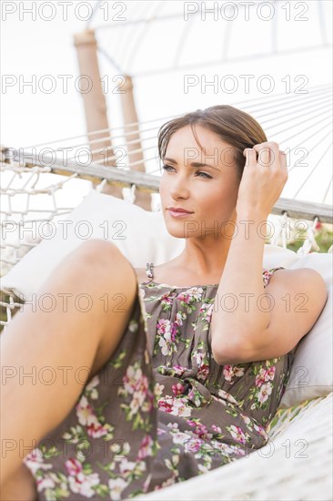 Caucasian woman laying in hammock