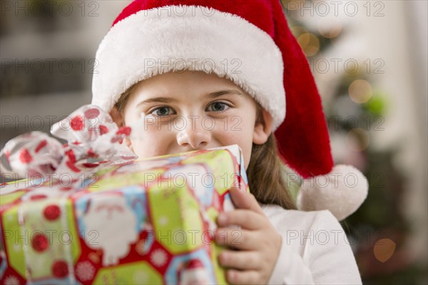 Caucasian girl holding Christmas gift