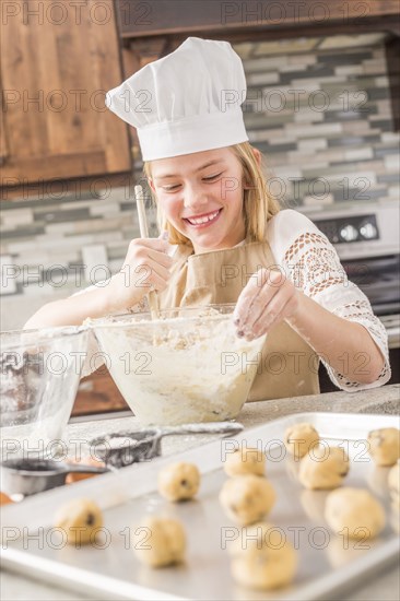 Caucasian girl baking in kitchen