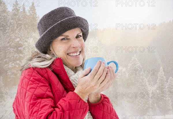 Caucasian woman drinking coffee in snow