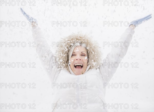 Caucasian woman playing in snow