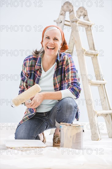 Caucasian woman painting in new home