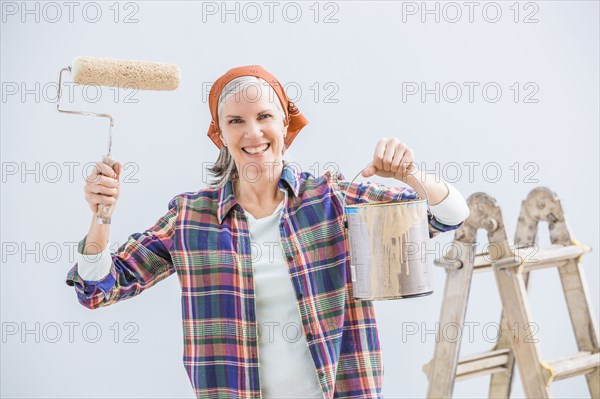 Caucasian woman painting in new home