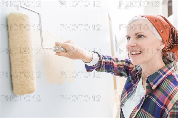 Caucasian woman painting in new home