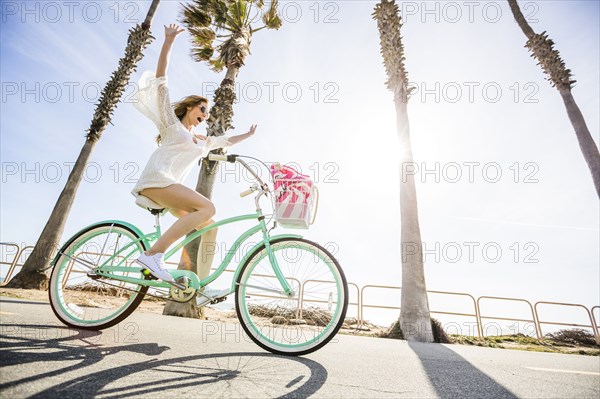 Caucasian woman riding bicycle