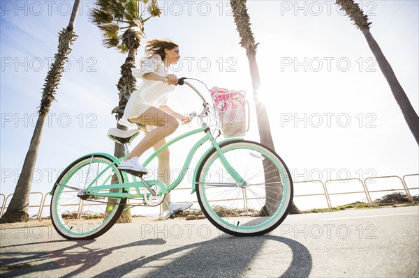 Caucasian woman riding bicycle