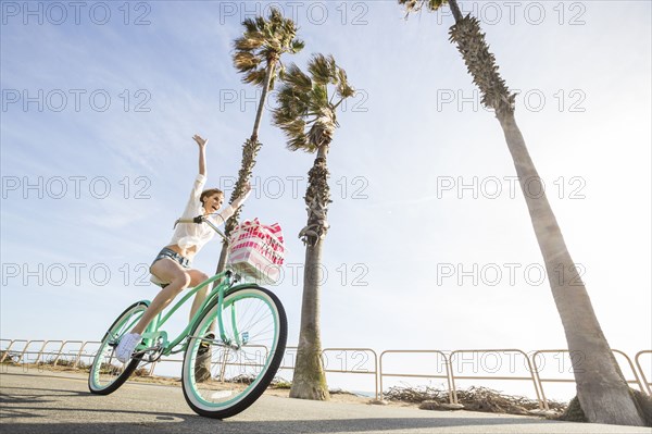 Caucasian woman riding bicycle