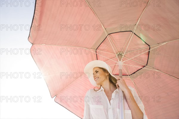 Caucasian woman holding umbrella