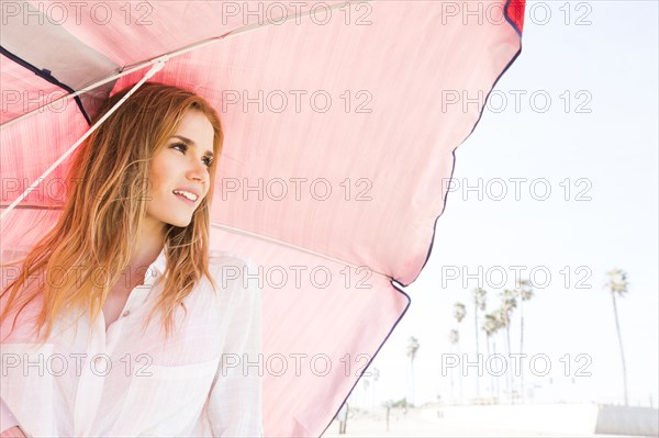 Caucasian woman holding umbrella