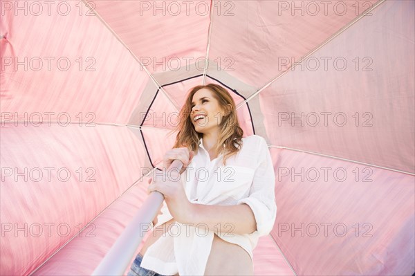 Caucasian woman holding umbrella