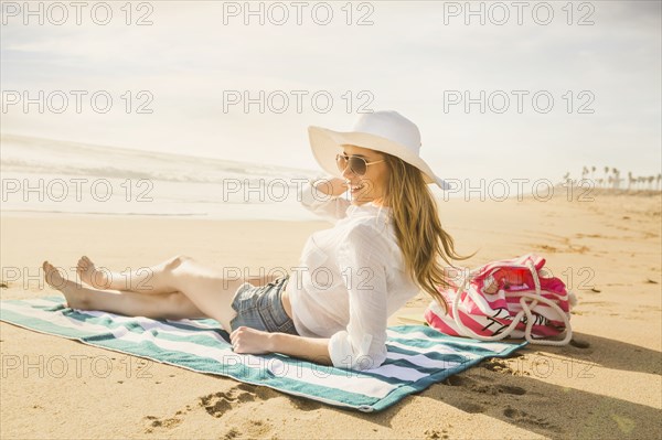 Caucasian woman laying on beach