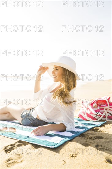 Caucasian woman laying on beach