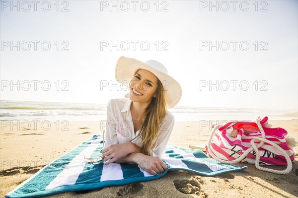 Caucasian woman laying on beach