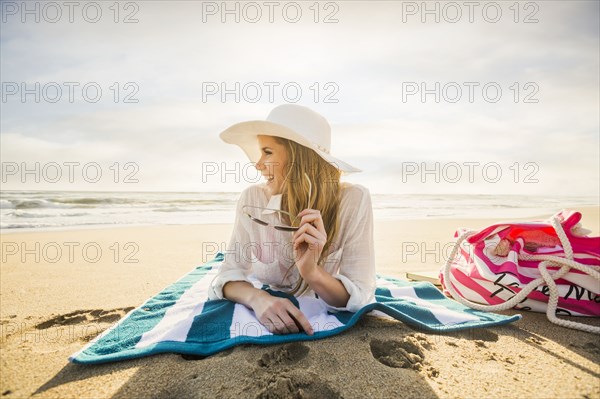 Caucasian woman laying on beach