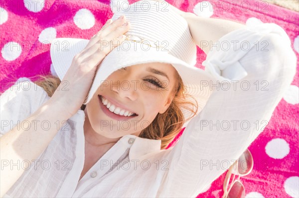 Caucasian woman laying on towel